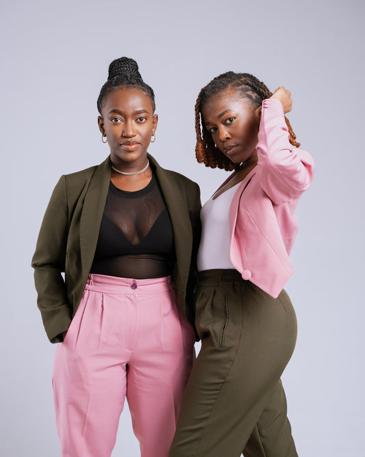Two women posing together against a plain background